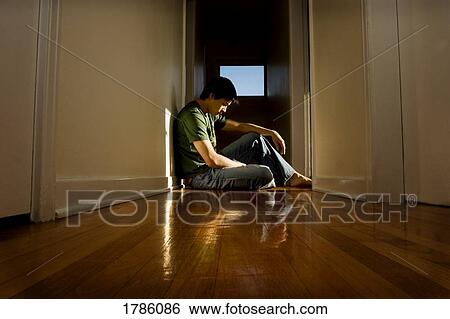 Man sitting in a hallway View Large Photo Image Stock Photograph - Man sitting in a hallway. Fotosearch
