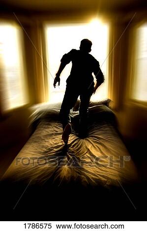 Stock Photography - Man walking towards the light. Fotosearch