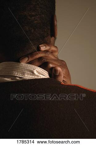 Picture - Man with a sore neck. Fotosearch
