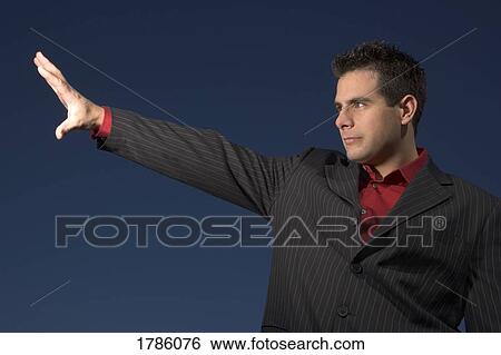 Stock Photograph - Man with arm outstretched. Fotosearch