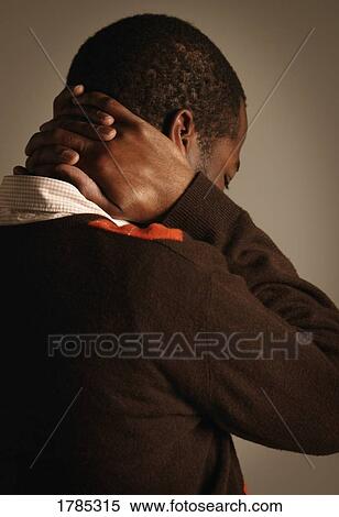Stock Photography - Man with hands on his neck. Fotosearch