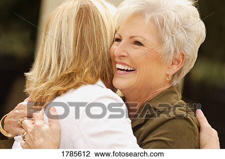Stock Image - Mother and daughter embracing. Fotosearch