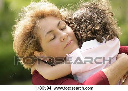 Mother and daughter hugging View Large Photo Image Picture - Mother and daughter hugging. Fotosearch