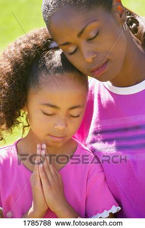 Mother and daughter praying View Large Photo Image Stock Photo - Mother and daughter praying. Fotosearch