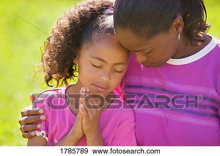 Mother and daughter praying View Large Photo Image Stock Photo - Mother and daughter praying. Fotosearch