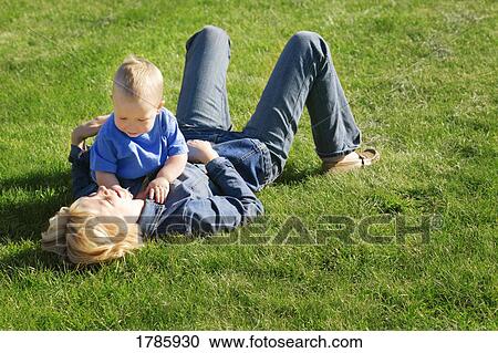 Stock Image - Mother and son playing in park. Fotosearch