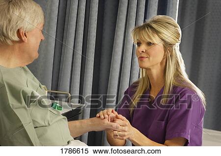 Nurse looking at sore hand View Large Photo Image Stock Photography - Nurse looking at sore hand. Fotosearch