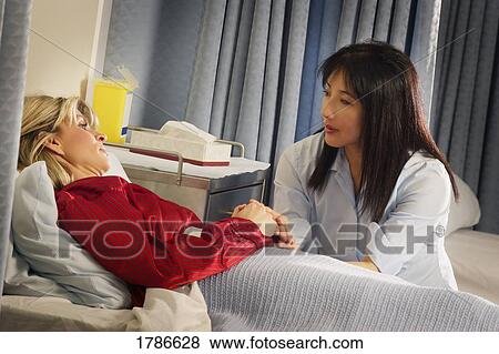 Nurse sitting with patient View Large Photo Image Stock Photo - Nurse sitting with patient. Fotosearch