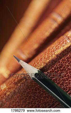 Stock Photo - One pencil on a stack of books. Fotosearch