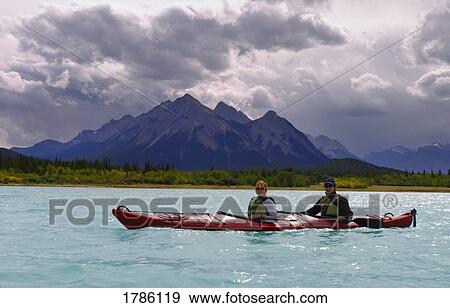 Paddlers on a lake View Large Photo Image Stock Photo - Paddlers on a lake. Fotosearch