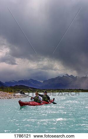 Stock Image - Paddlers on a mountain lake. Fotosearch