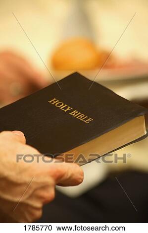 Person holding a Bible View Large Photo Image Stock Image - Person holding a Bible. Fotosearch