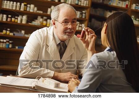 Pharmacist giving medical advice to patient View Large Photo Image Stock Photo - Pharmacist giving medical advice to patient. Fotosearch