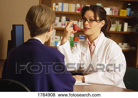 Pharmacist instructing patient View Large Photo Image Stock Photo - Pharmacist instructing patient. Fotosearch