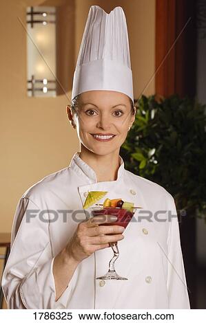 Stock Photography - Portrait of chef presenting tropical drink. Fotosearch