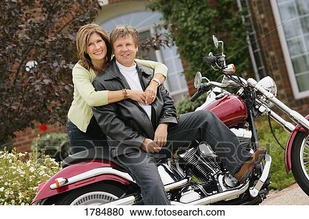 Stock Image - Portrait of man and woman on a motorcycle. Fotosearch