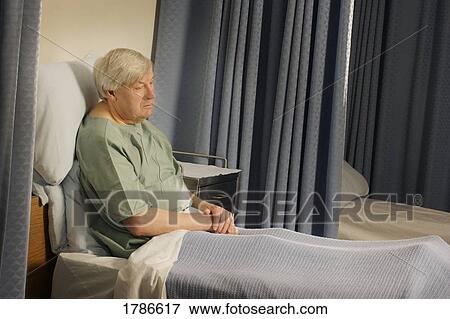 Stock Photo - Senior in a hospital bed. Fotosearch