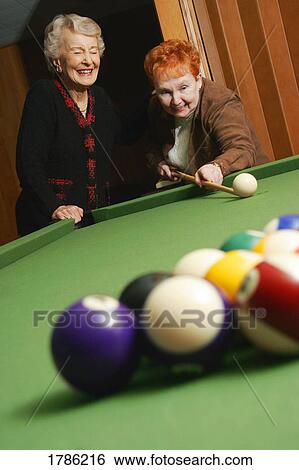 Seniors playing a pool game View Large Photo Image Stock Photograph - Seniors playing a pool game. Fotosearch