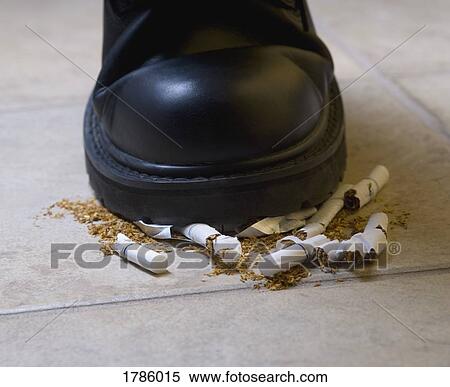Stock Photography - Shoe crushing cigarettes. Fotosearch