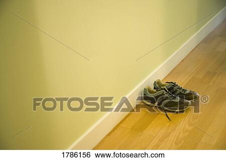 Stock Photograph - Shoes sitting in a hallway. Fotosearch