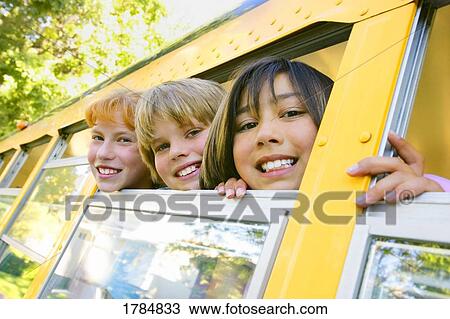 Stock Image - Smiling children on school bus. Fotosearch