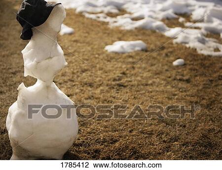 Stock Image - Snowman melting in spring. Fotosearch
