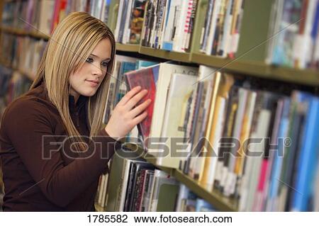 Stock Image - Teen in library. Fotosearch