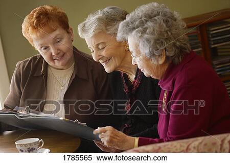 Three ladies enjoying photos View Large Photo Image Stock Photography - Three ladies enjoying photos. Fotosearch