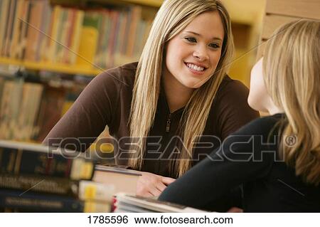 Two girls in library View Large Photo Image Stock Photograph - Two girls in library. Fotosearch