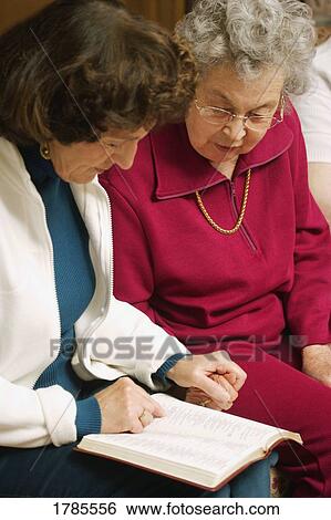 Two women praying together View Large Photo Image Stock Photograph - Two women praying together. Fotosearch