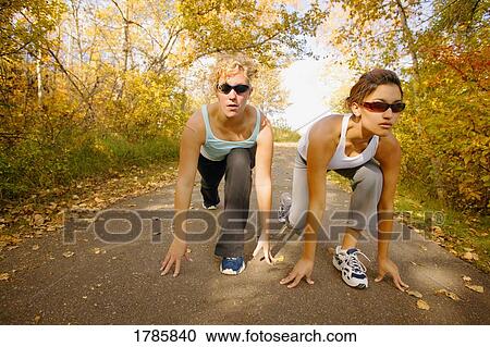 Two women stretching View Large Photo Image Stock Image - Two women stretching. Fotosearch