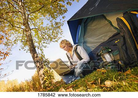 Woman camping with computer View Large Photo Image Stock Image - Woman camping with computer. Fotosearch