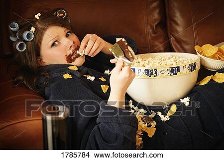Woman gets caught eating junk food View Large Photo Image Picture - Woman gets caught eating junk food. Fotosearch