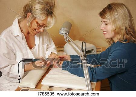 Stock Photography - Woman having a manicure. Fotosearch