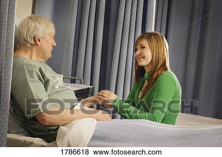 Woman visiting senior in hospital room View Large Photo Image Stock Photo - Woman visiting senior in hospital room. Fotosearch