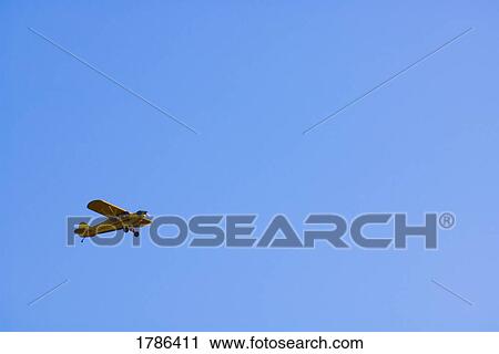 Yellow two seater airplane flying View Large Photo Image Stock Image - Yellow two seater airplane flying. Fotosearch