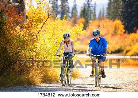 Stock Image - Young couple on their bikes. Fotosearch