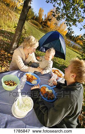 Young family camping View Large Photo Image Stock Photo - Young family camping. Fotosearch