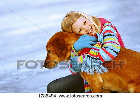 Young girl embracing her dog View Large Photo Image Picture - Young girl embracing her dog. Fotosearch