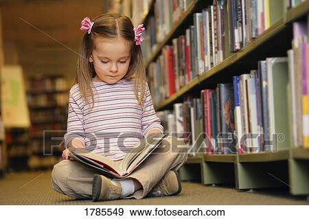 Stock Photo - Young girl reading a book. Fotosearch