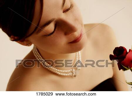 Young woman with a rose View Large Photo Image Stock Photo - Young woman with a rose. Fotosearch