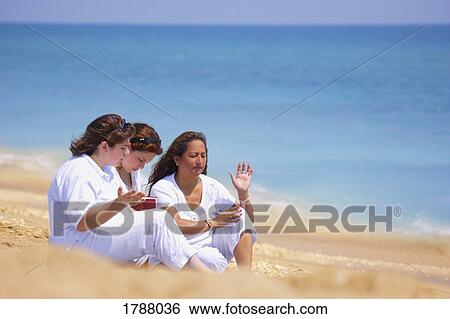 A group of women unite in prayer on the beach Stock Photograph | 1788036 | Fotosearch