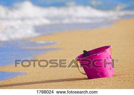 Beach bucket in sand View Large Photo Image Picture - Beach bucket in sand. Fotosearch