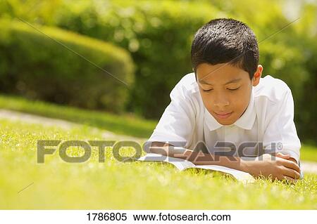 Boy reading a book View Large Photo Image Stock Photography - Boy reading a book. Fotosearch