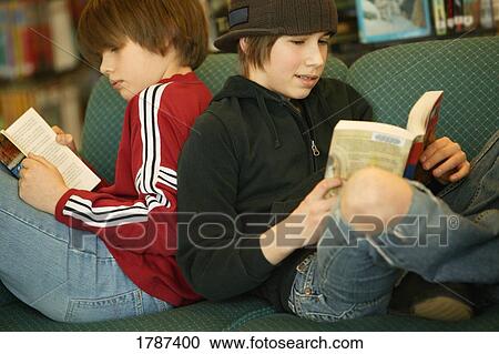 Stock Image - Boys reading books. Fotosearch