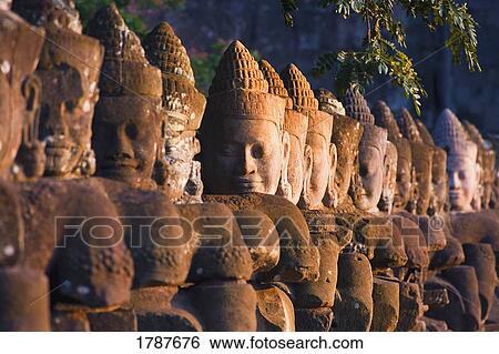Stock Photograph - Buddha Head Statues, Angkor Wat Temple. Fotosearch