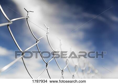 Chain linked fence against blue sky View Large Photo Image Picture - Chain linked fence against blue sky. Fotosearch