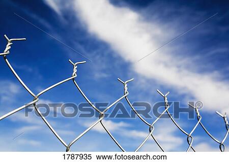 Chain linked fence against blue sky View Large Photo Image Stock Photography - Chain linked fence against blue sky. Fotosearch