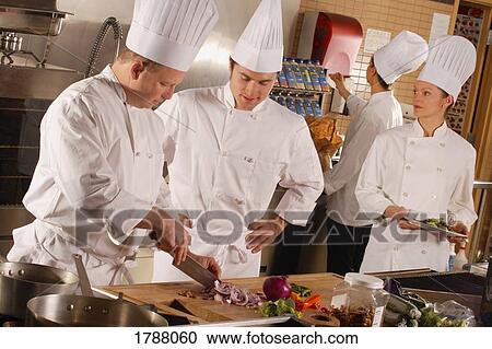 Chefs cooking in the kitchen View Large Photo Image Stock Image - Chefs cooking in the kitchen. Fotosearch