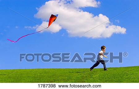Stock Photo - Child flying a kite. Fotosearch